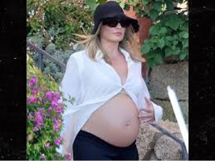  REVEALED: Pregnant Margot Robbie Shows Off Her Bare Baby Bump as She Vacations with Husband Tom Ackerley in Sardinia as they prepare for the arrival of their ... Read More